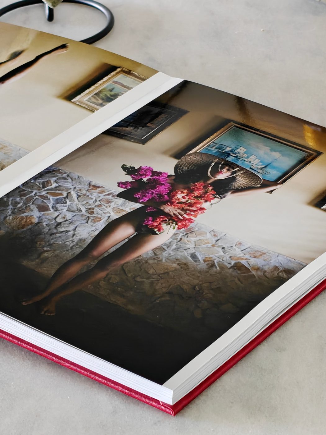 Open NiNE photobook showing a floral portrait and landscape photography